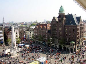 Dam Square in Amsterdam seen from above, with the National Monument and crowds on the square