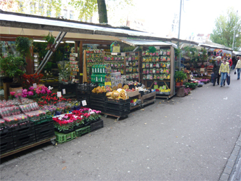 The row of flower market stalls along the pavement
